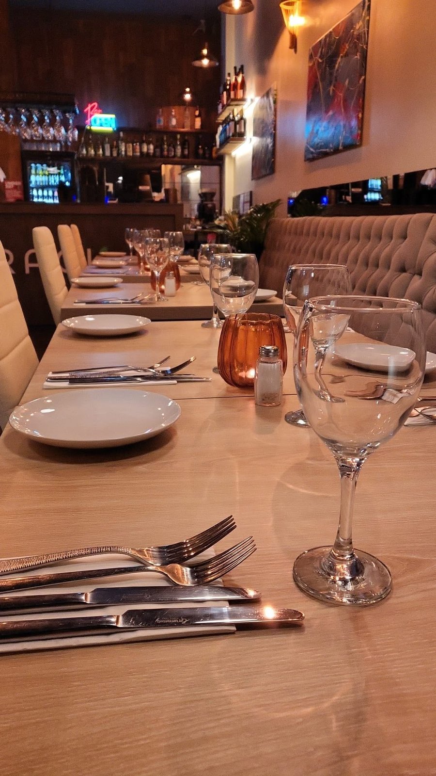 Table set for dinner at Ragù Italian Bistro, with the bar in the background